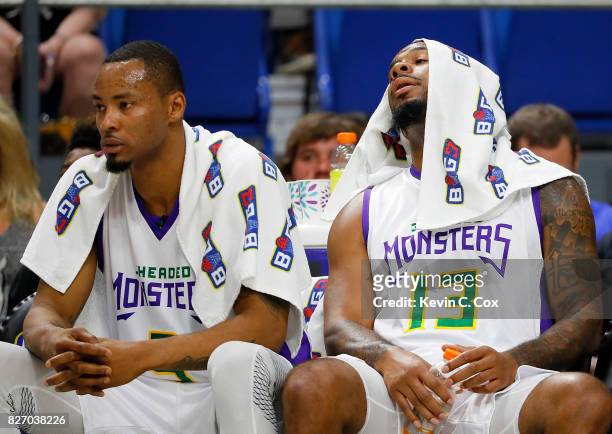 Rashard Lewis and Eddie Basden of the 3 Headed Monsters react on the bench during a time out during the game against the Ball Hogs during week seven...