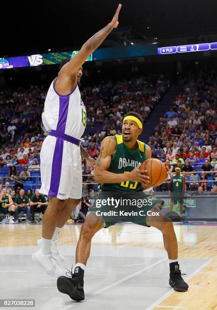 Desmon Farmer of the Ball Hogs is guarded by Eddie Basden of the 3 Headed Monsters as he drives the basket during week seven of the BIG3 three on...