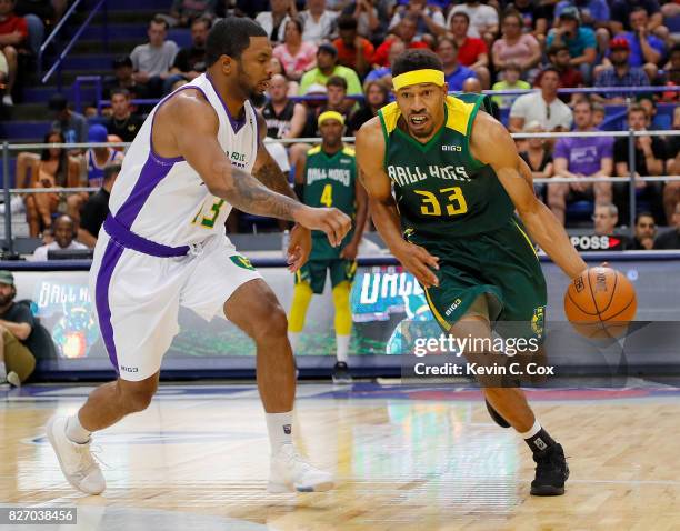 Desmon Farmer of the Ball Hogs drives the basket while being guarded by Eddie Basden of the 3 Headed Monsters during week seven of the BIG3 three on...