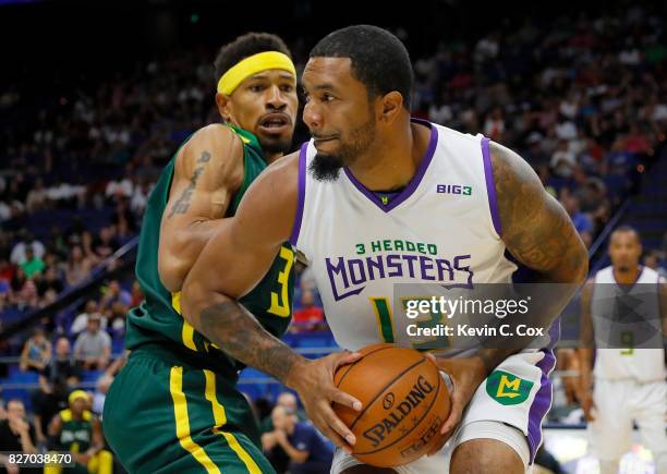 Eddie Basden of the 3 Headed Monsters is guarded by Desmon Farmer of the Ball Hogs during week seven of the BIG3 three on three basketball league at...