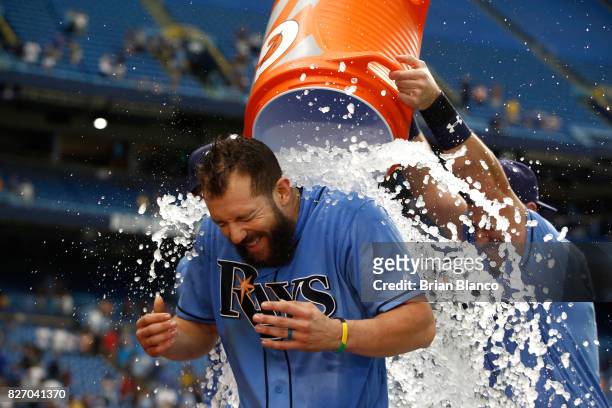 Steven Souza Jr. #20 of the Tampa Bay Rays is doused with ice by teammates after hitting a walk-off home run off of pitcher Jacob Barnes of the...