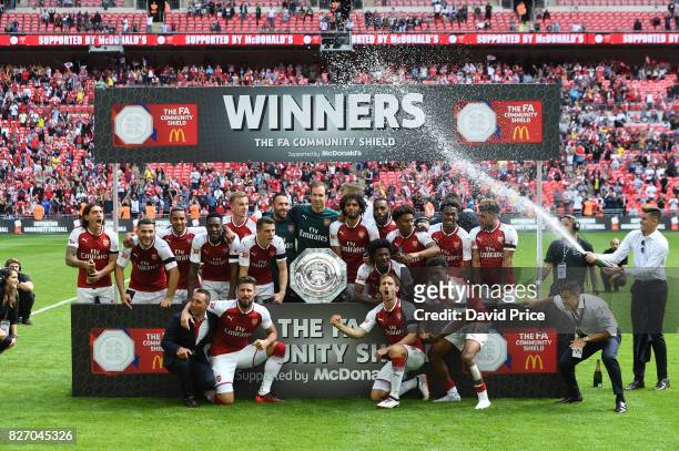 The Arsenal players celebrate winning the Community Shield after the match between Chelsea and Arsenal at Wembley Stadium on August 6, 2017 in...