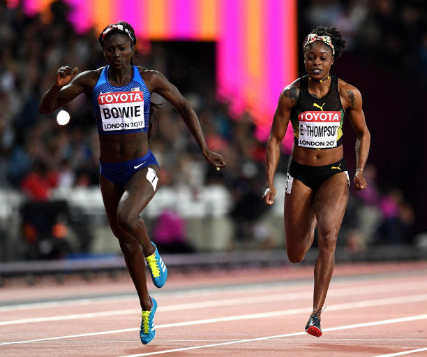 Tori Bowie of the United States crosses the finish line to win the Women's 100 Metres Final ahead of Elaine Thompson of Jamaica during day three of...