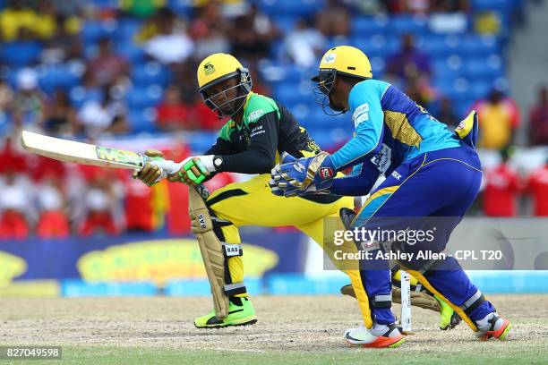 In this handout image provided by CPL T20, Andre McCarthy of Jamaica Tallawahs plays a sweep shot, while Nicholas Pooran of the Barbados Tridents...