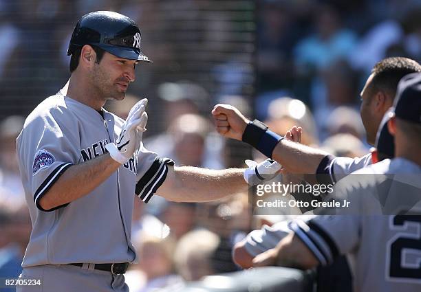 Xavier Nady of the New York Yankees is congratulated by teammates after hitting a home run in the second inning against the Seattle Mariners on...