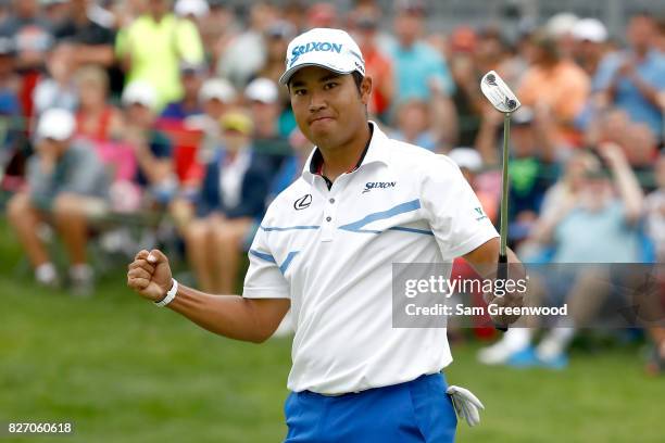 Hideki Matsuyama of Japan reacts on the 18th green after putting for birdie during the final round of the World Golf Championships - Bridgestone...