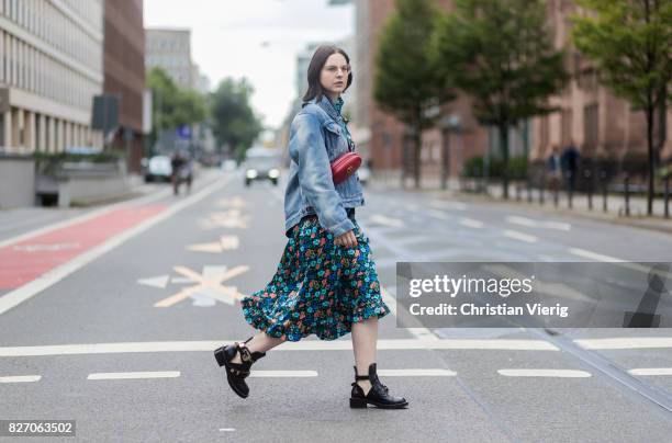 Fashion blogger and stylist Maria Barteczko wearing a light blue Balenciaga denim jacket, a Vetements dress with floral print, red Gucci belt bag,...