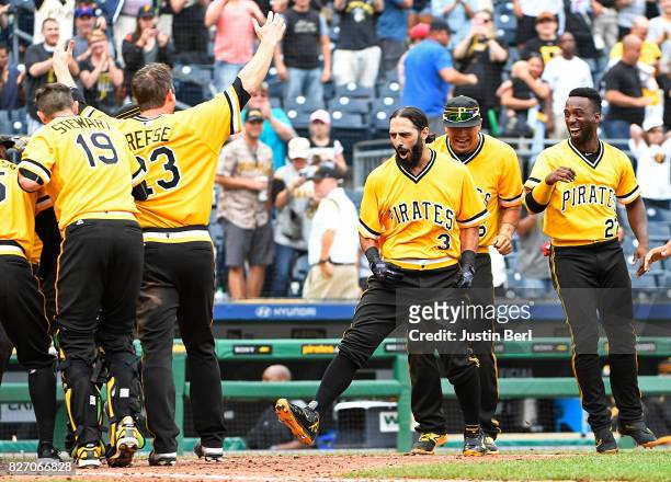Sean Rodriguez of the Pittsburgh Pirates celebrates with teammates as he rounds the bases after hitting a walk off home run to give the Pittsburgh...