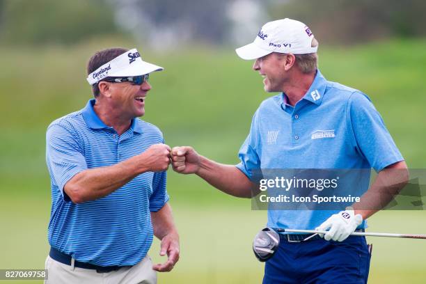 Brandt Jobe and Steve Stricker fist bump as they walk down the fairway on the 1st hole during the Final Round of the 3M Championship on August 6,...
