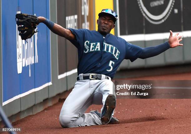 Guillermo Heredia of the Seattle Mariners slides as he catches a foul ball hit by Melky Cabrera of the Kansas City Royals in the first inning in game...