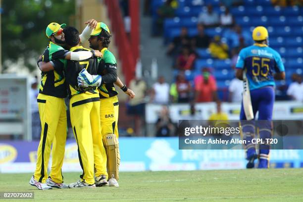 In this handout image provided by CPL T20, Imad Wasim, Mohammed Sami and Kumar Sangakarra of Jamaica Tallawahs celebrates the wicket of Kieron...