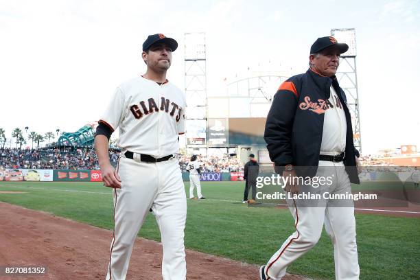 Starting pitcher Matt Moore and pitching coach Dave Righetti of the San Francisco Giants walk to the dugout before the interleague game against the...