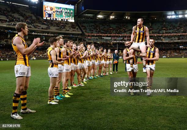 Jarryd Roughead of the Hawks is chaired off after his 250th game by Shaun Burgoyne and Jack Gunston of the Hawks during the 2017 AFL round 20 match...