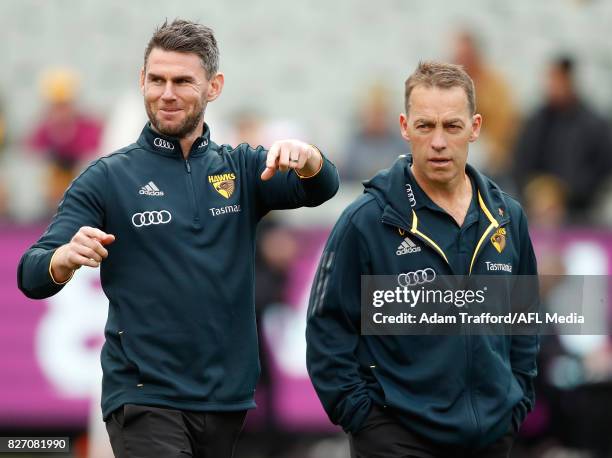 Chris Newman, Senior Coach of the Box Hill Hawks chats to Alastair Clarkson, Senior Coach of the Hawks during the 2017 AFL round 20 match between the...