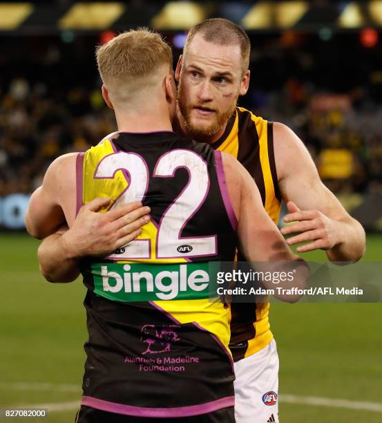 Josh Caddy of the Tigers congratulates Jarryd Roughead of the Hawks on his 250th game during the 2017 AFL round 20 match between the Richmond Tigers...