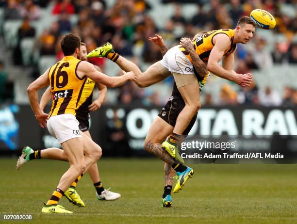 Liam Shiels of the Hawks is tackled by Dustin Martin of the Tigers during the 2017 AFL round 20 match between the Richmond Tigers and the Hawthorn...