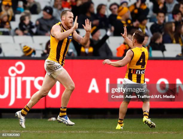 Jarryd Roughead of the Hawks celebrates a goal in his 250th game with Billy Hartung of the Hawks during the 2017 AFL round 20 match between the...