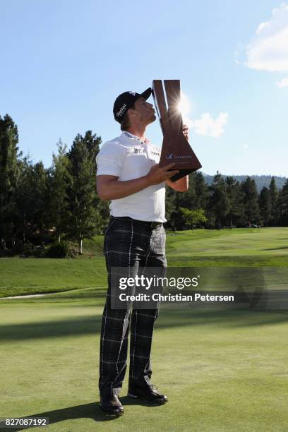 Chris Stroud poses with the trophy after putting in to win during a second play-off hole during the final round of the Barracuda Championship at...