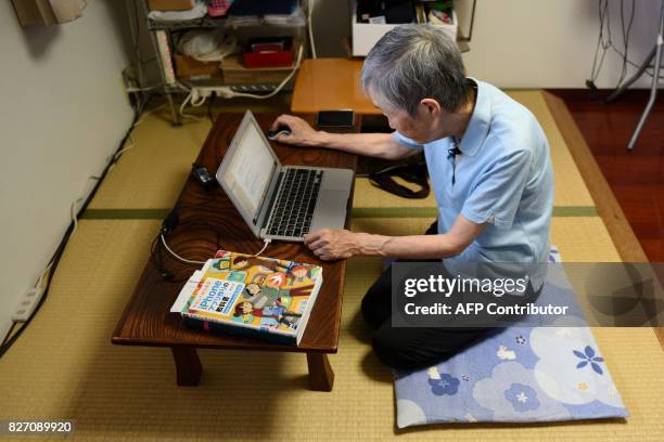 This picture taken on July 13, 2017 shows 82-year-old programmer Masako Wakamiya using a laptop in her home in Fujisawa, Kanagawa prefecture. When...