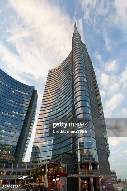 street view of the unicredit tower entrance in piazza gae aulenti, milan-italy - edificio adibito a uffici stock pictures, royalty-free photos & images