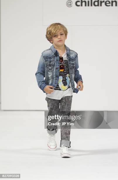 Young model walks the runway for True Religion collection during petitePARADE at Children's Club at Jacob Javitz Center on August 6, 2017 in New York...