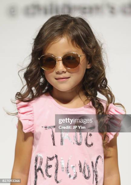 Young model walks the runway for True Religion collection during petitePARADE at Children's Club at Jacob Javitz Center on August 6, 2017 in New York...