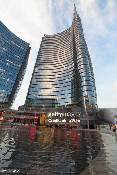 street view of the unicredit tower entrance in piazza gae aulenti, milan-italy - vita cittadina stock pictures, royalty-free photos & images