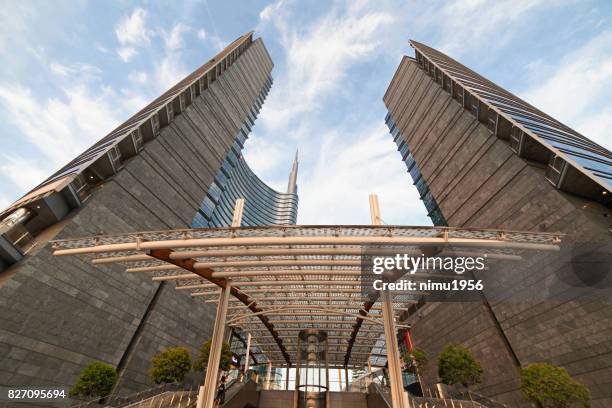 street view of the unicredit tower entrance in piazza gae aulenti, milan-italy - inquadratura dal basso stock pictures, royalty-free photos & images