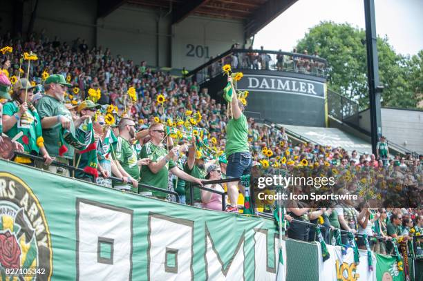 Portland Timbers fans display sunflowers at the 80s minute to sing "you are my sunshine" in honor of former mascot "Timber" Jim's daughter during the...