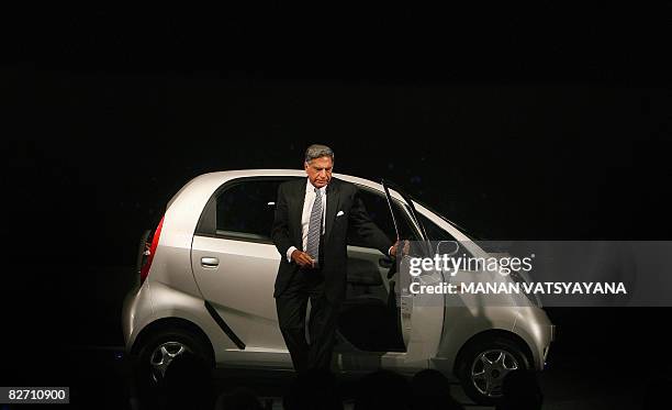 In this file photograph taken on January 10 chairman of the Tata Group, Ratan Tata comes out of the new Tata "Nano" car during the unveiling ceremony...