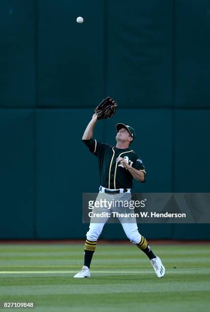 Jaycob Brugman of the Oakland Athletics catches a fly ball off the bat of Hunter Pence of the San Francisco Giants in the top of the first inning at...