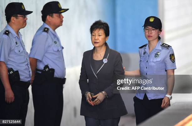 South Korea's ousted president Park Geun-Hye arrives at the Seoul Central District Court in Seoul on August 7, 2017 for her trial over the massive...