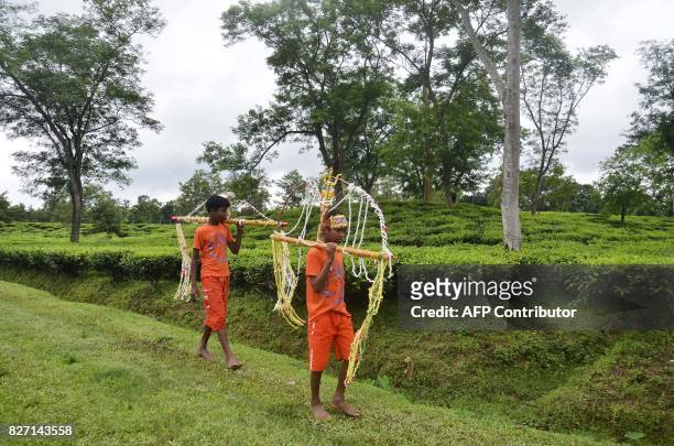 Devotees participate in the Kanwar Yatra pilgrimage on the occasion of Sawan festival in Dharmanagar, in the northeastern state of Tripura on August...