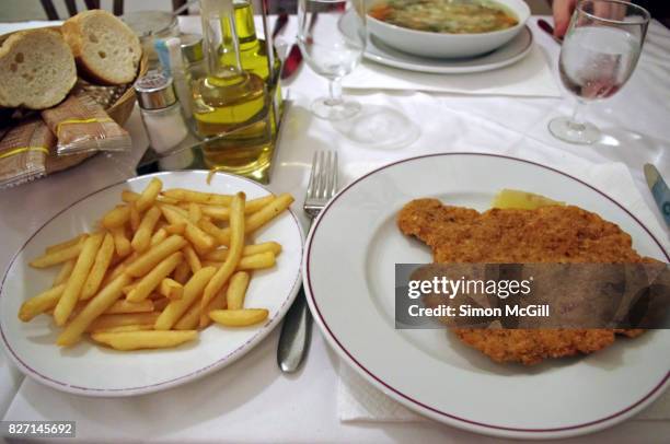 veal milanese and french fries in a restaurant in venice, italy - milanese stockfoto's en -beelden