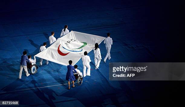 Flagbearers carry the International Paralympics Committee flag during the 2008 Beijing Paralympic Games opening ceremony at the National Stadium,...