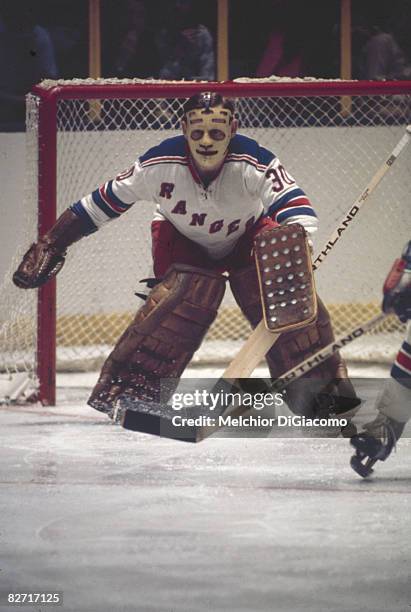 Canadian ice hockey player Gilles Villemure, goalkeeper for the New York Rangers, guards the net during a game, late 1960s or early 1970s.
