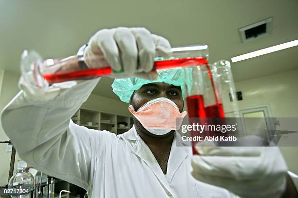 Scientist mixes liquids at the Middle East Company for Pharmaceutical Industries September 08, 2008 in Bait Hanoun, Gaza Strip. Constructed in 1999,...
