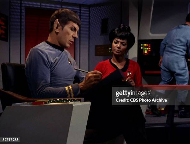 American actor Leonard Nimoy speaks to actress Nichelle Nichols on the bridge of the USS Enterprise in a scene from 'The Man Trap,' the premiere...