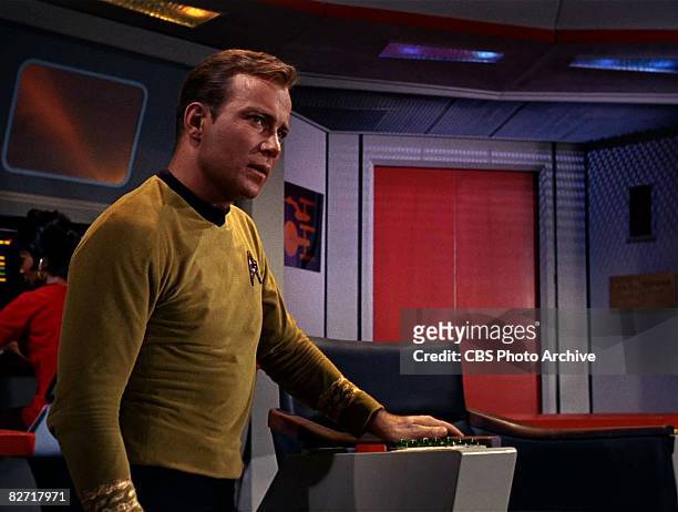 Canadian actor William Shatner sits on the bridge of the USS Enterprise in a scene from 'The Man Trap,' the premiere episode of 'Star Trek,' which...