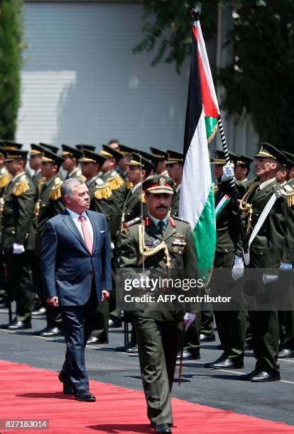 Jordan's King Abdullah II observes the honor guard during a visit in the West Bank city of Ramallah on August 7, 2017. Jordan's King began a rare...