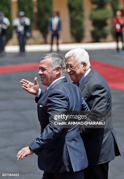 Jordan's King Abdullah II and Palestinian president Mahmud Abbas gesture during a visit in the West Bank city of Ramallah on August 7, 2017. Jordan's...