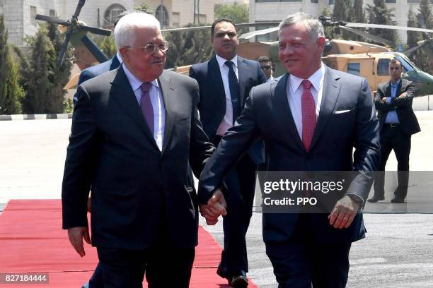 In this handout image supplied by the office of the Palestinian president, King Abdullah II of Jordan is greeted by Palestinian President Mahmoud...