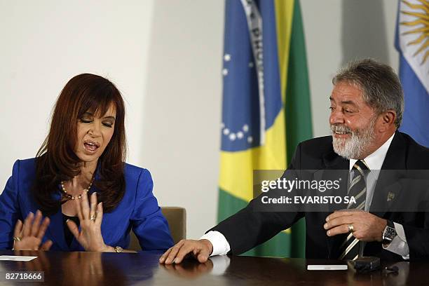 Argentina's President Cristina Fernandez de Kirchner and Brazil's President Luiz Inacio Lula da Silva joke during a signing of agreements ceremony at...