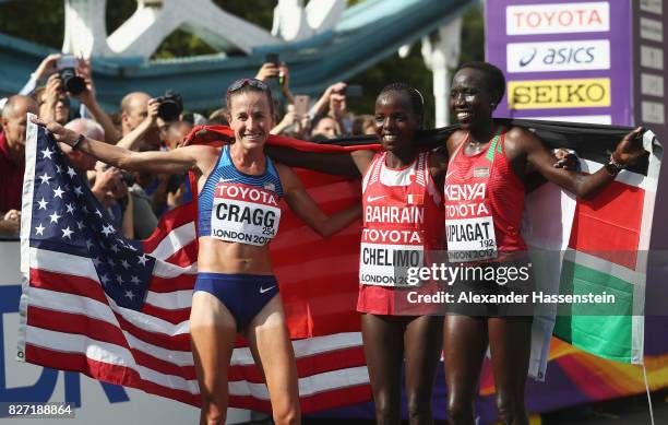 Amy Cragg of the United States, third place, Rose Chelimo of Bahrain, first place, and Edna Ngeringwony Kiplagat of Kenya, second place, celebrate...