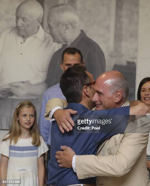 King Felipe VI of Spain looks on as Bernard Ruiz-Picasso and Joan Punyet Miro embrace during a visit the Can Prunera Museum on August 6, 2017 in...
