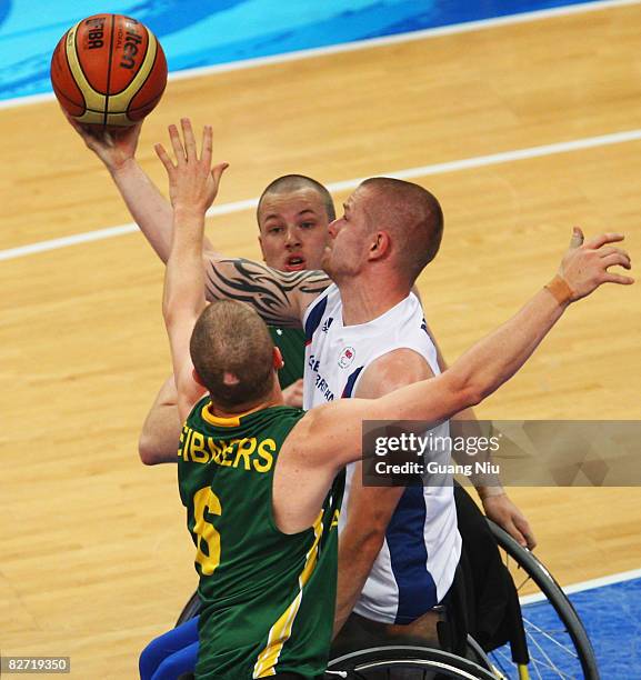 Joseph Bestwick of Great Britain tries to shoot a ball from Brett Stibners and Shaun Norris of Australia in the Wheelchair Basketball match between...