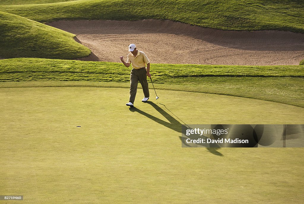 Golfer celebrating making putt
