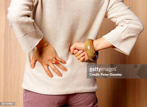 woman with backache - rheumatism stock pictures, royalty-free photos & images