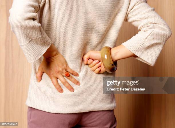 woman with backache - osteoporose imagens e fotografias de stock