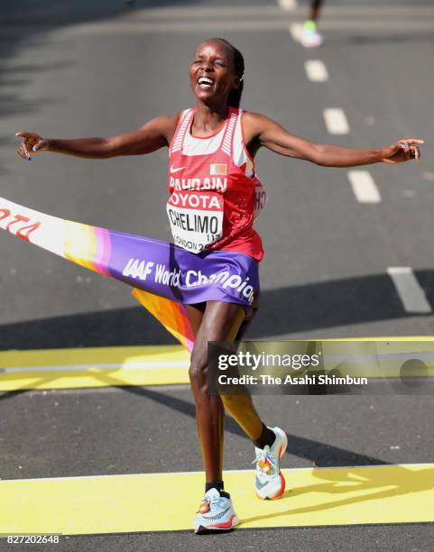 Rose Chelimo of Bahrain crosses the finish tape to win the gold medal in the Women's Marathon during day three of the 16th IAAF World Athletics...